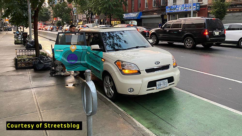image of car parked in bike lane on grand street